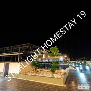a sign that is lit up at night at Star Light Homestay 19@ The Venus in Sitiawan