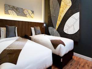 En eller flere senge i et værelse på Siam Swana