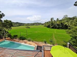 a view of the golf course from the balcony of a villa at Sugoi House in Unawatuna