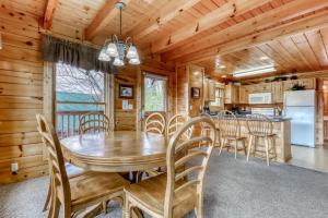 a dining room with a wooden table and chairs at Above the Pines in Pigeon Forge