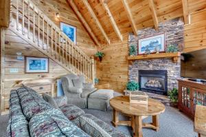 a living room with a couch and a fireplace at Above the Pines in Pigeon Forge