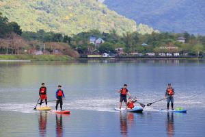 a group of people on paddle boards on a lake at 500Km Home in Hualien City