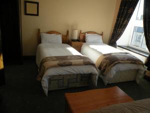 Letto o letti in una camera di Buggle's Pub and Accommodation