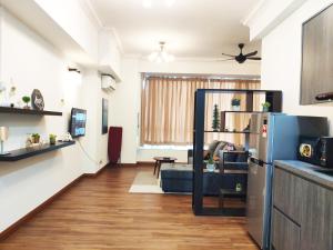 a kitchen with a refrigerator and a living room at Parkview KLCC by Salaam Suites, 4 pax in Kuala Lumpur +15 photos