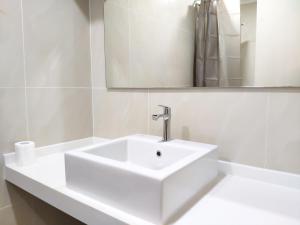 a white bathroom with a sink and a mirror at Parkview KLCC by Salaam Suites, 4 pax in Kuala Lumpur