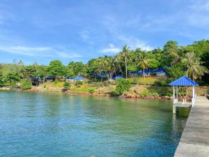 a dock with a gazebo next to a river at Koh Mak Buri Hut Natural Resort in Ko Mak