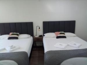A bed or beds in a room at Appin Village Motel