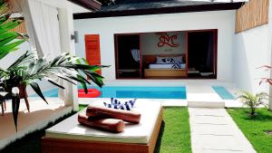 a backyard with a swimming pool and a house at Montecarlo Villas Panglao in Panglao