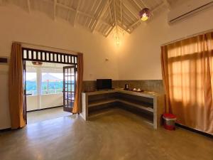 a room with a table and a window and a door at The Horizon Hill Top Villa in Unawatuna