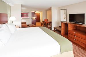 a hotel room with a large bed and a flat screen tv at Holiday Inn Express & Suites Niagara Falls by IHG in Niagara Falls +57 photos