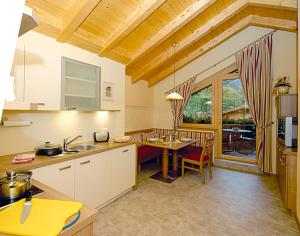 a kitchen with a table and a dining room at Appartement Zottl in Mayrhofen