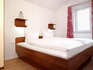 Dänische Ferienhäuser am Salzhaff Haus Pacific في إنسيل بويل: سريرين توأم في غرفة بها نافذة