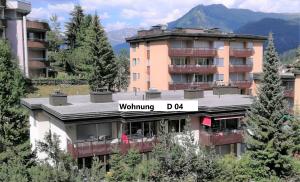 a building with a sign on top of it at Quellenhof D04 in Davos