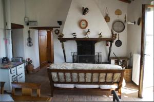 a living room with a fireplace and a bed in it at Villa Podere Isabella in Radicofani