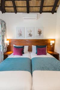 two beds sitting next to each other in a bedroom at Kruger Park Lodge Unit No. 608A in Hazyview