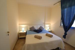 A bed or beds in a room at Bright Apartment Near The Beach In Otranto