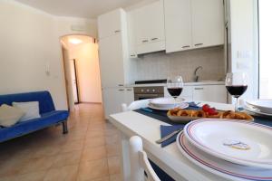 A kitchen or kitchenette at Bright Apartment Near The Beach In Otranto