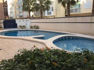 a swimming pool in the middle of a building at Beach House Brotonss in El Campello