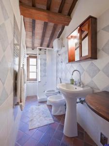 a bathroom with a sink and a toilet at Tenuta La Silva in Seggiano