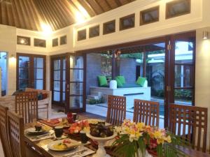 a dining room with a table with food on it at Villa Zamaya Sanur in Sanur