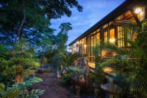 a house with a lot of plants in front of it at Cattani's Riverside Home in Phra Nakhon Si Ayutthaya