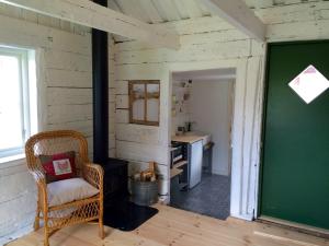 a room with a chair and a green chalkboard at The Fork and Shovel Farm in Bräcke