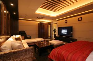Habitación de hotel con cama y TV de pantalla plana. en HOTEL W-PREMIUM -W GROUP HOTELS and RESORTS- en Koshigaya