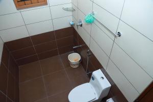 a bathroom with a white toilet in a room at Anand homestay in Kattappana