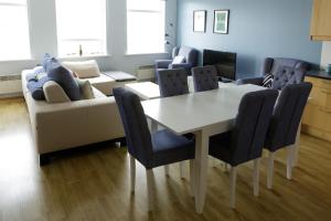 a living room with a table and a couch at Hildibrand Apartment Hotel in Neskaupstaður