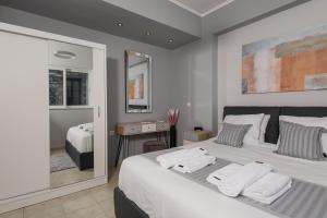 a bedroom with a large bed with towels on it at nelion 01 - a DREAM apartment with amazing view in Aigio