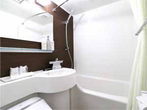 
a bathroom with a sink, toilet and bathtub at Central Hotel Okayama in Okayama
