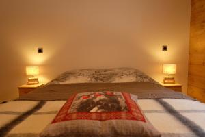 ティーニュにあるAppartement Soleil Blanc Résidence Lodge des neigesのベッドルーム1室(両側にランプ2つ付)