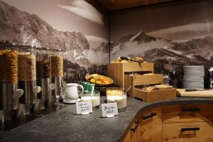 a kitchen with a counter with some food on it at Hotel Garni Zugspitz in Farchant