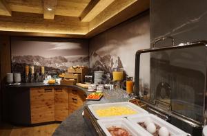 a kitchen with a counter with food on it at Hotel Garni Zugspitz in Farchant