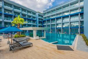 a large building with a swimming pool in front of it at BlueSotel SMART Krabi Aonang Beach - Adults only in Ao Nang Beach