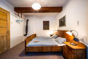 a bedroom with a bed with a blue and white mattress at Hájenka Harrachov in Harrachov