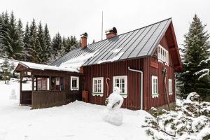 a snowman statue in front of a red house at Hájenka Harrachov in Harrachov