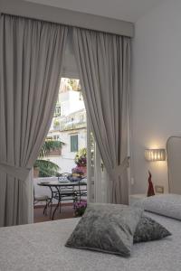 a bedroom with a bed and a view of a patio at Palazzo Gargano Amalfi in Amalfi