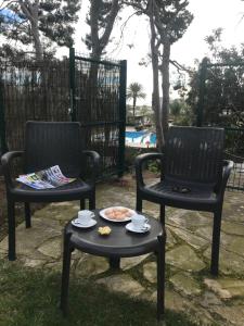 two chairs and a table with a plate of food at VILLA CATALUNYA in Cambrils