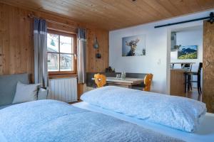 a bedroom with a bed and a desk and a window at Bergbauernhof Pabulariu in Boden