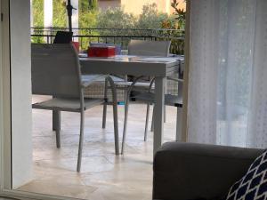 a table and chairs sitting on a balcony at Maxima Sunset in Sainte-Maxime