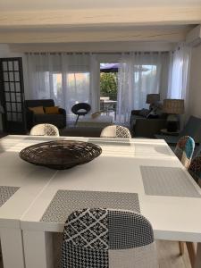 a living room with a table and chairs at Maxima Sunset in Sainte-Maxime