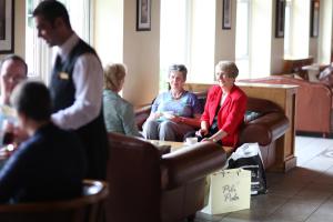 a group of people sitting in a waiting room at Stradey Park Hotel in Llanelli