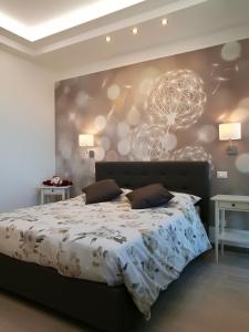 a bedroom with a bed and a wall with a tree mural at Settimo Cielo in Florence