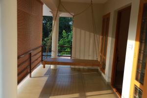 a porch swing in a house with a balcony at Anand homestay in Kattappana