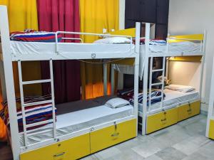 a room with two bunk beds in a room at The Desire Hostel in New Delhi