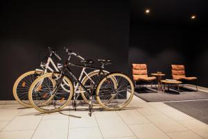 two bikes on display in a room with chairs at ipartment Hamburg HafenCity in Hamburg