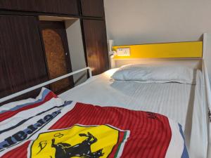 a bed with a yellow and red blanket on it at The Desire Hostel in New Delhi