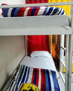 two bunk beds in a room with another bunk bed at The Desire Hostel in New Delhi