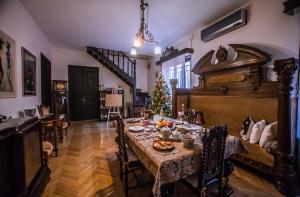 a dining room with a table and a christmas tree at Home 12 in Tbilisi City